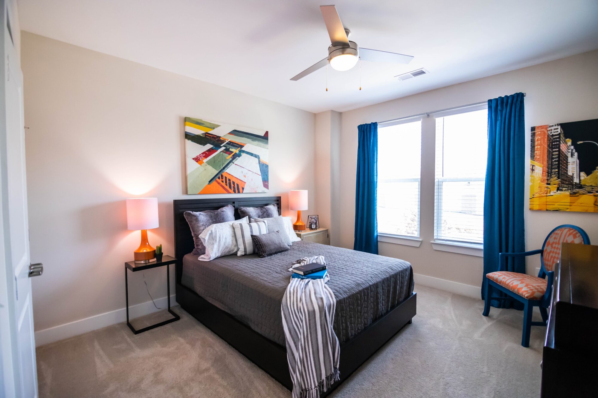Staged bedroom with large window and ceiling fan